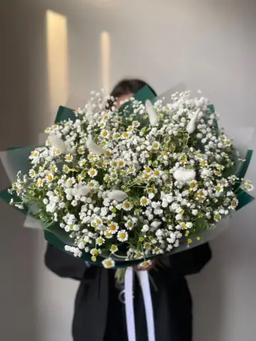 Field bouquet of daisies and gypsophila